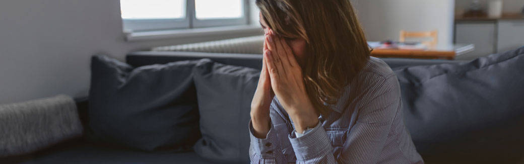 upset woman with her head in her hands